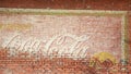 Vintage Coca Cola ad on a brick wall